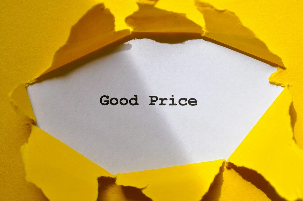 Yellow paper torn to reveal 'Good Price'. Perfect for sales and marketing concepts.